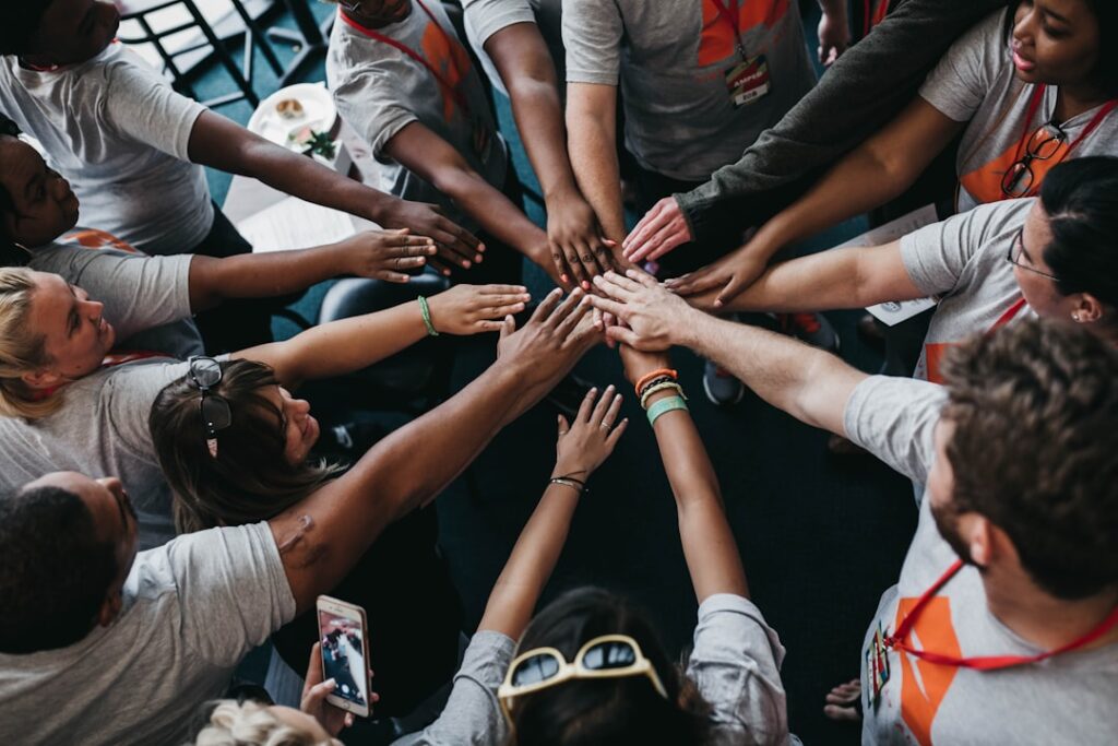 People placing their hands together; illustrative photograph representing connection