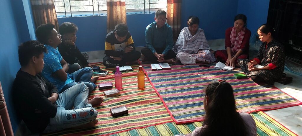Young adults gathered in a circle for a BCBT Bible study