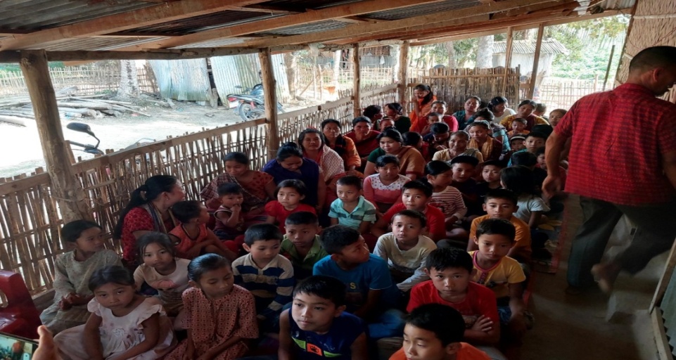 Children participating in a BCBT ministry gathering under a village shelter
